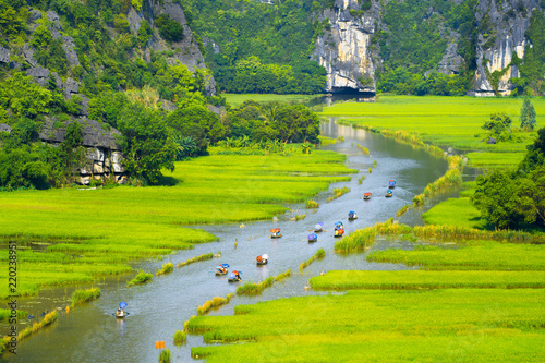 Tourist ride boat for travel sight seeing Rice field on river 