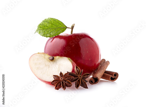 Red apple with leaf, cinnamon and anise on white background
