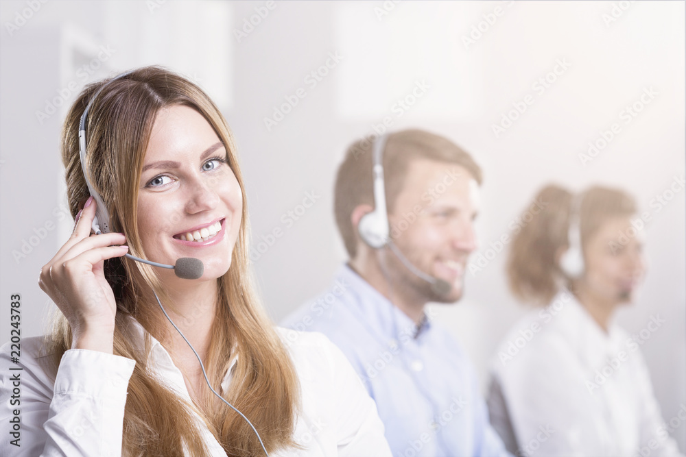 Smiling woman with headset during customer service in call center Smiling woman with headset during customer service in call center