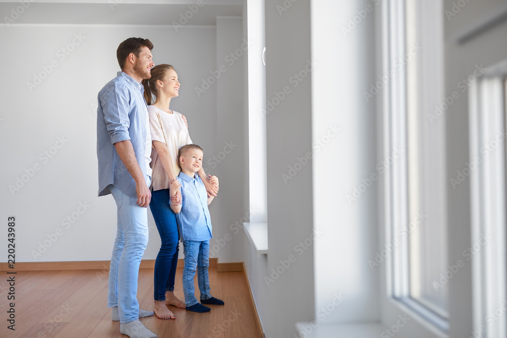 family, people and real estate concept - happy mother, father and little son looking through window at new home or apartment family, people and real estate concept - happy mother, father and little son looking through window at new home or apartment