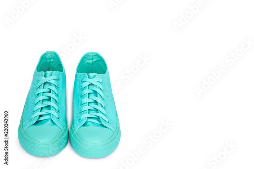 Turquoise rubber sneakers, casual footwear isolated on white background, copy space template