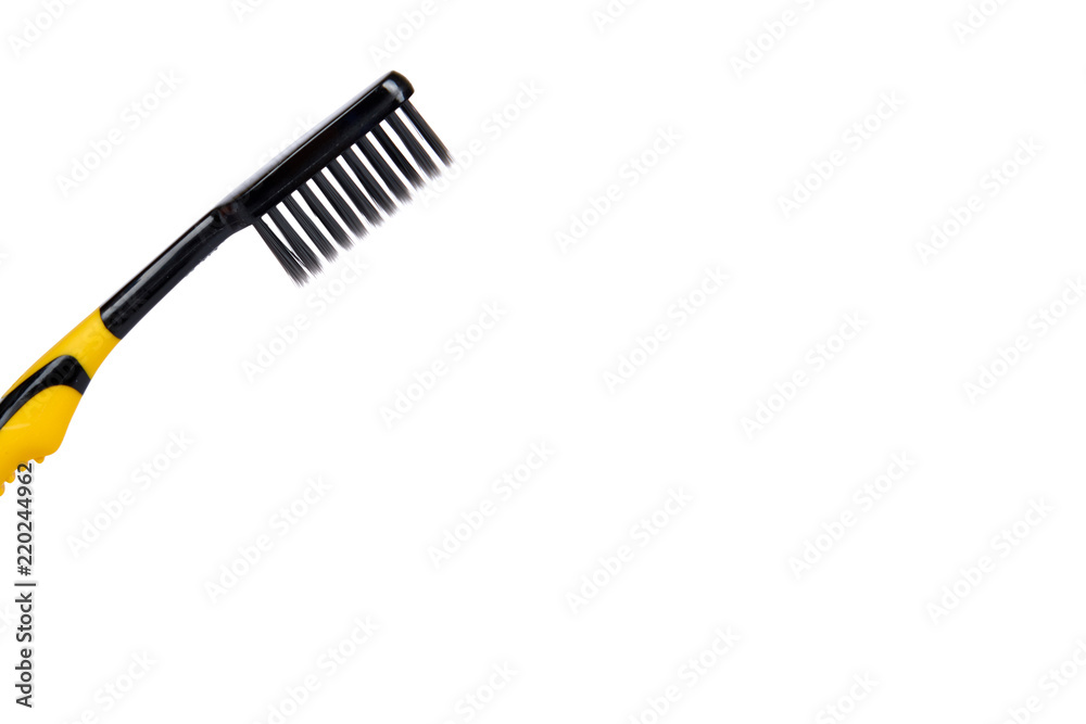 Black and yellow soft toothbrush isolated on white background, copy space template Black and yellow soft toothbrush isolated on white background, copy space template