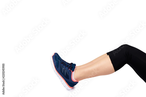 Fit female leg in sport shoe isolated on white background, copy space template