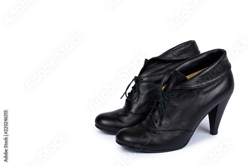 Female black leather high heel shoes isolated on white background, copy space template