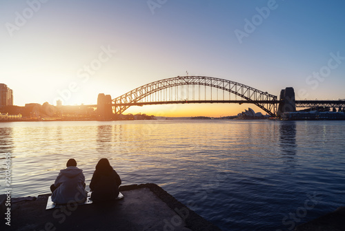 Canvas Print Romantic couple looks at Sydney skyline at dusk in Sydney New South Wales, Australia