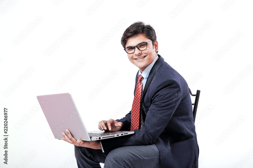 Young Indian businessmen using laptop over isolated background. Young Indian businessmen using laptop over isolated background.