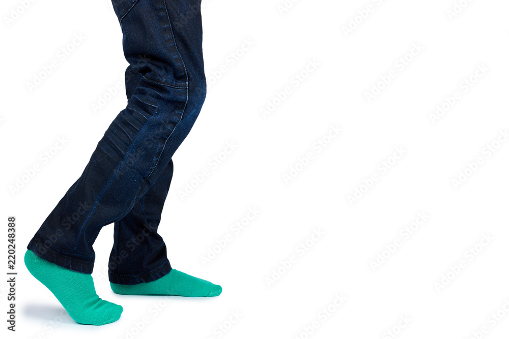Naklejka premium Kid legs in colored socks on leg isolated on white background, copy space template