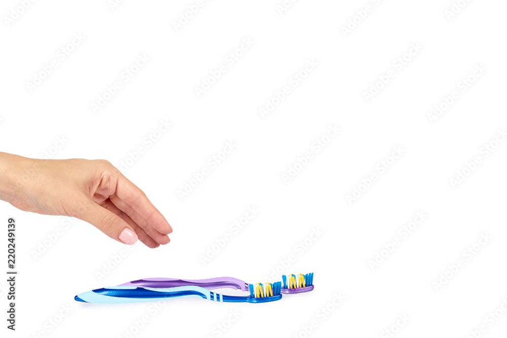 Color new toothbrush with hand isolated on a white background, copy space template. Color new toothbrush with hand isolated on a white background, copy space template.