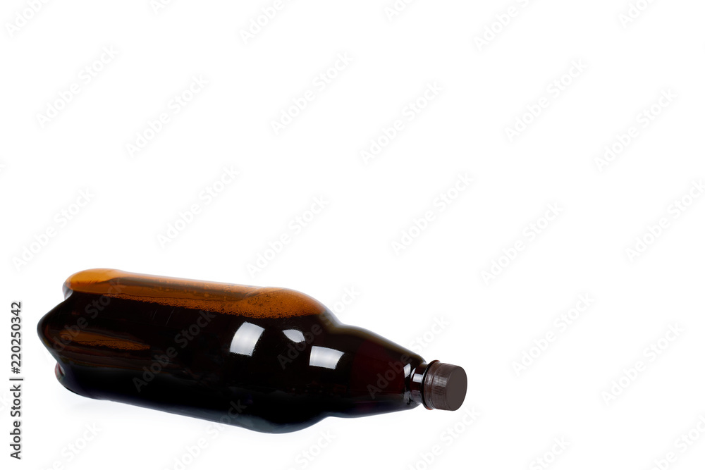Dark brown plastic bottle of beer or kvass isolated on a white background, copy space template. Dark brown plastic bottle of beer or kvass isolated on a white background, copy space template.