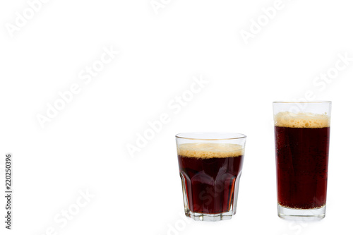 Cold glass of dark beer or kvass with foam isolated on white background, copy space template.