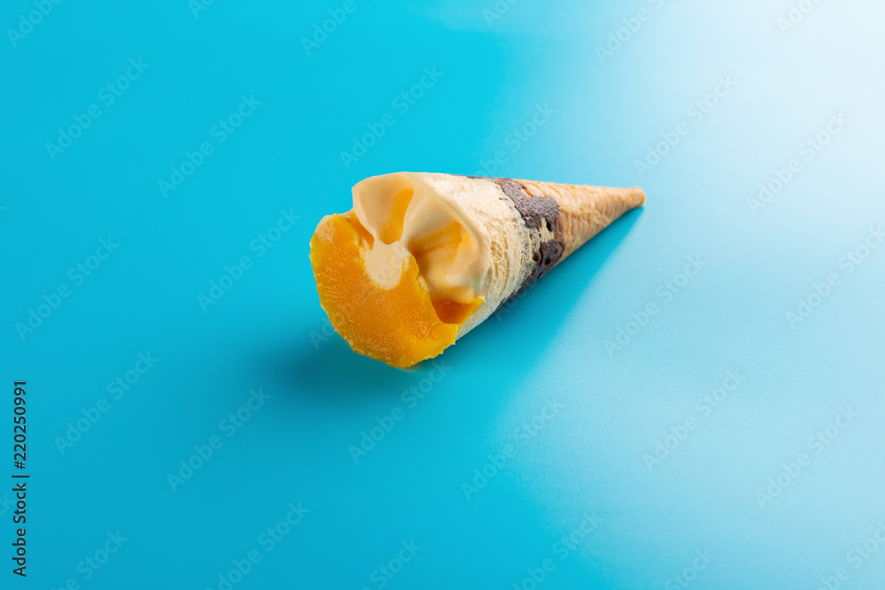 mini mango or orange flavor ice cream cone on blue background
