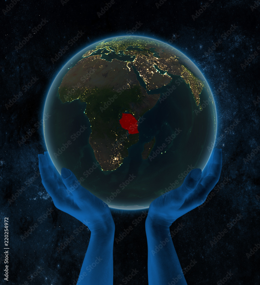 Tanzania on night Earth in hands in space Tanzania on night Earth in hands in space