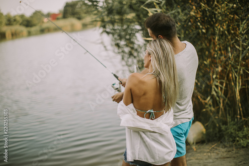 Lovely young couple fishing...