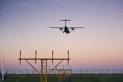 Airplane landing at dusk