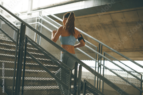 Young woman running alone up stairs