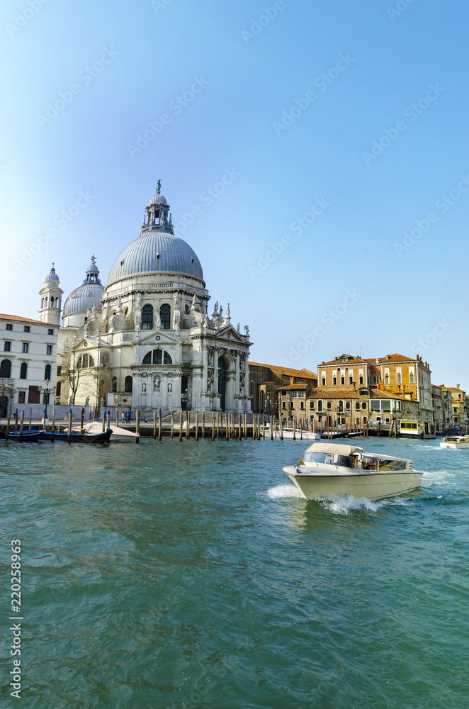 Yacht boat on Grand Canal and Basilica Santa Maria della Salute, Venice, Italy