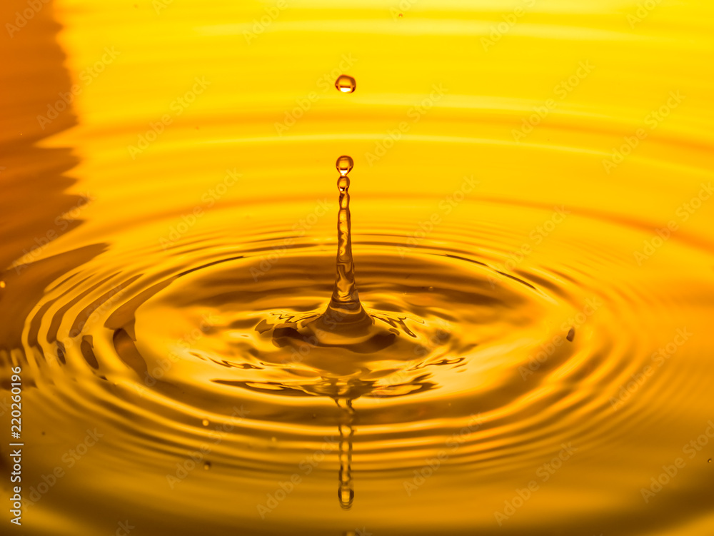Close Up of a Drop Oil on a Yellow Background Stock Image - Image