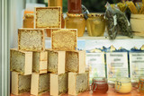 Jars of honey, Honey in honeycombs, production of honey on farm market counter, real scene in food market