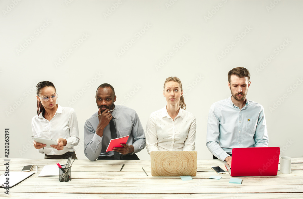 Young african and caucasian men and women sitting at office and working on laptops. The business, emotions, team, teamwork, workplace, leadership, meeting concept. different emotions of colleagues Young african and caucasian men and women sitting at office and working on laptops. The business, emotions, team, teamwork, workplace, leadership, meeting concept. different emotions of colleagues