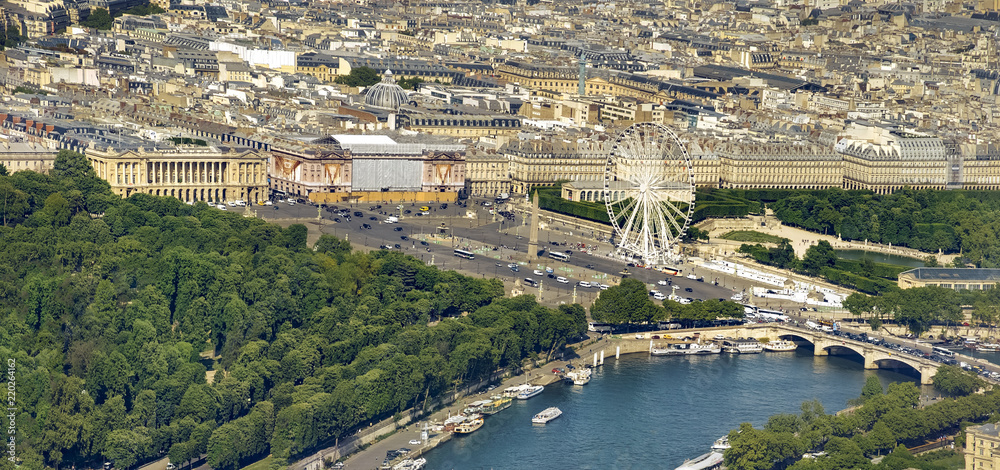 Panoramic view of Paris and Seine river with Concorde square, Ferris Wheel and obelisk from thet top of Eiffel Tower, Paris, France