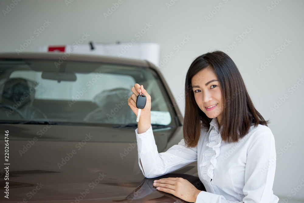 Young Happy Woman Showing The Key Of her New Car, Dream comes true concept, Asian sales woman with casual suit