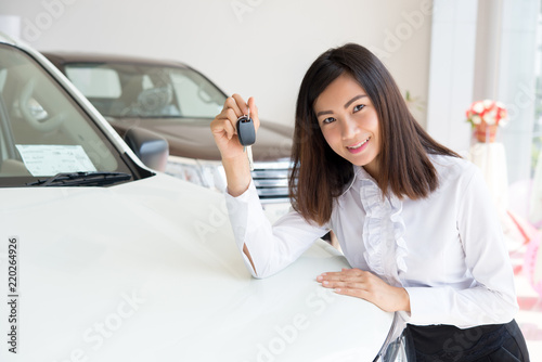 Young Happy Woman Showing The Key Of her New Car, Dream comes true concept, Asian sales woman with casual suit