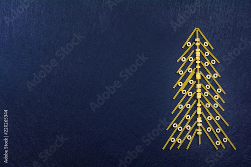 Christmas tree made with italian spaghetti on a slate background.