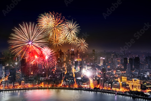 celebration freworks and light from modern city skyscrapers and reflection of beautiful ligth in Huangpu river, Shanghai, China