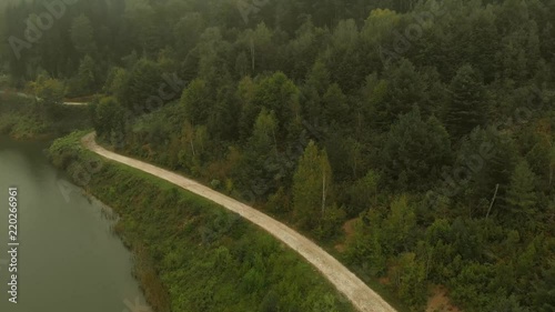 Aerial view of lake on mountain Goc in the fog. First signs of autumn, yellow ends on leaves. Mountain Goc - Serbia. photo