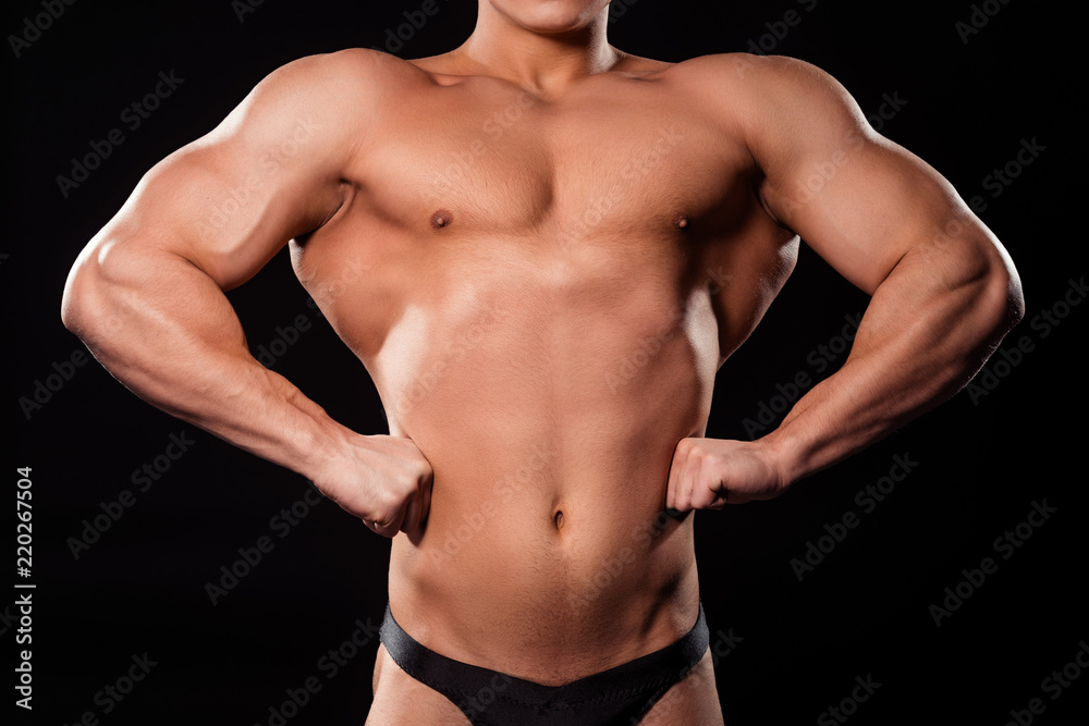 Bodybuilder's front lat spread pose.