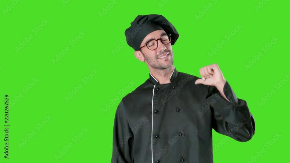Proud young chef pointing to himself against green background Proud young chef pointing to himself against green background
