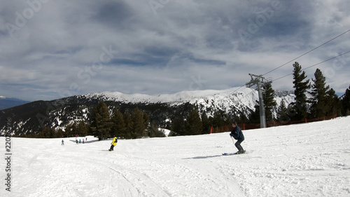 Skier ski in short turns down the ski slope track