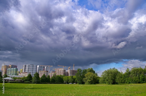 Houses under construction against a stormy sky