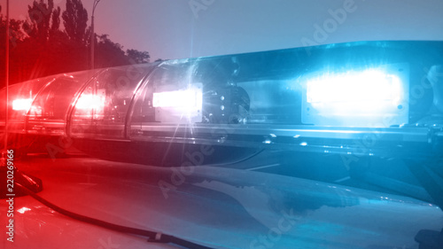 Tablou pe pânză Emergency vehicle lights flashing, police car inspecting city, security service