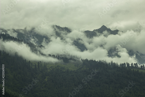 heavy dark cloud on the green hills and peak mountain