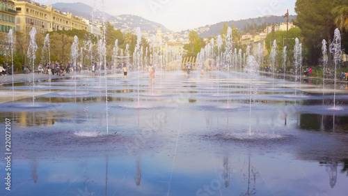 Children romping in fountain at Promenade du Paillon in Nice, summer holidays photo