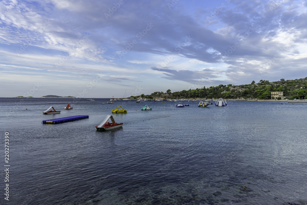A view of the seaside with people on the beach in Srebreno, Croatia. A view of the seaside with people on the beach in Srebreno, Croatia.