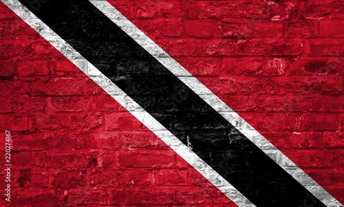 Flag of Trinidad and Tobago over an old brick wall background, surface © Domagoj
