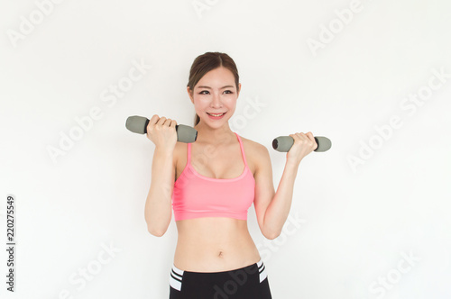 Sports concept. Beautiful girl is exercising in the home with warm up. Beautiful girl is happy to exercise.Beautiful women playing sports for health.