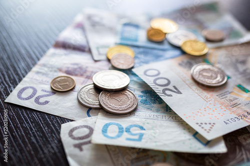 Stack of polish zloty banknotes and coins