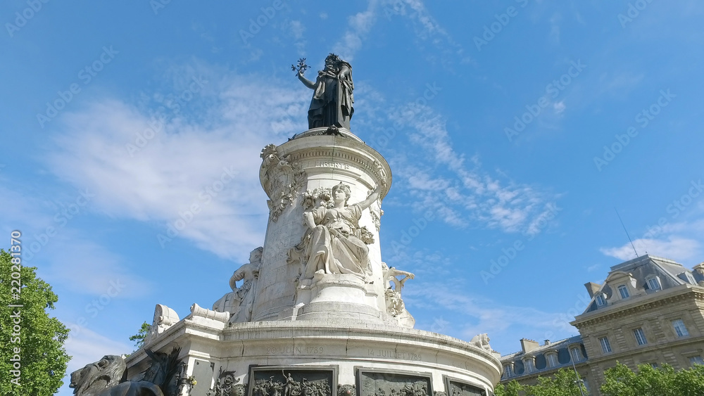 Bronze statue of Marianne in the center of the Place de la Republique square in Paris, France. Marianne holds an olive branch in her right hand. Hyperlapse shot