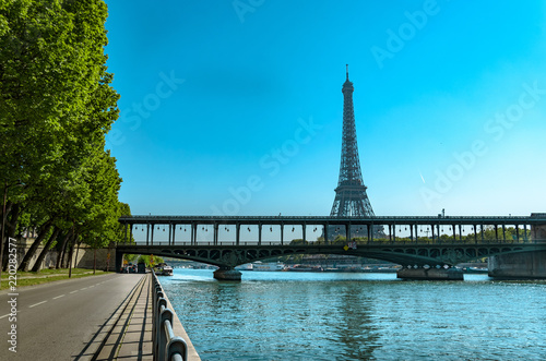Seine in Paris with Eiffel Tower, Bir Hakeim metro bridge and empti road at sunrise in Paris, France © zefart
