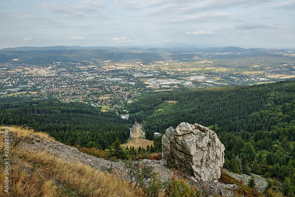 Obraz premium Czech landscape with big stone above Liberec city viewed from Jested hill at summer evening sunset 50 years after soviet occupation of Czechoslovakia 1968