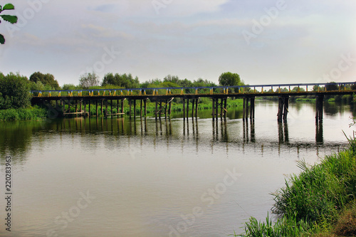 wooden bridge across the river © Alla 