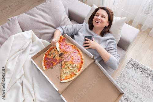 woman eating pizza image taken from above photo