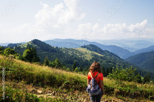 Girl in the mountains, a traveler photographed from the back © julianjuly