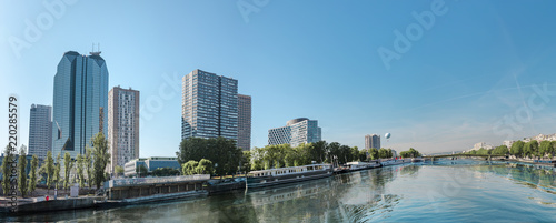 Boats on Seine river in Paris, France. View from place of The Statue of Liberty to modern buildings district
