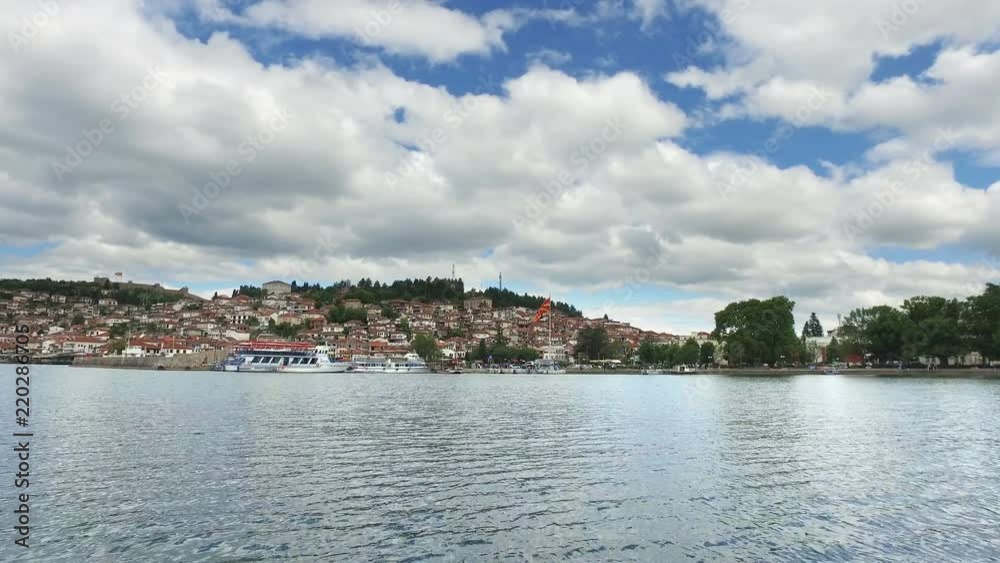 View of Ohrid town architecture and port from moving boat on lake. Cinematic view View of Ohrid town architecture and port from moving boat on lake. Cinematic view