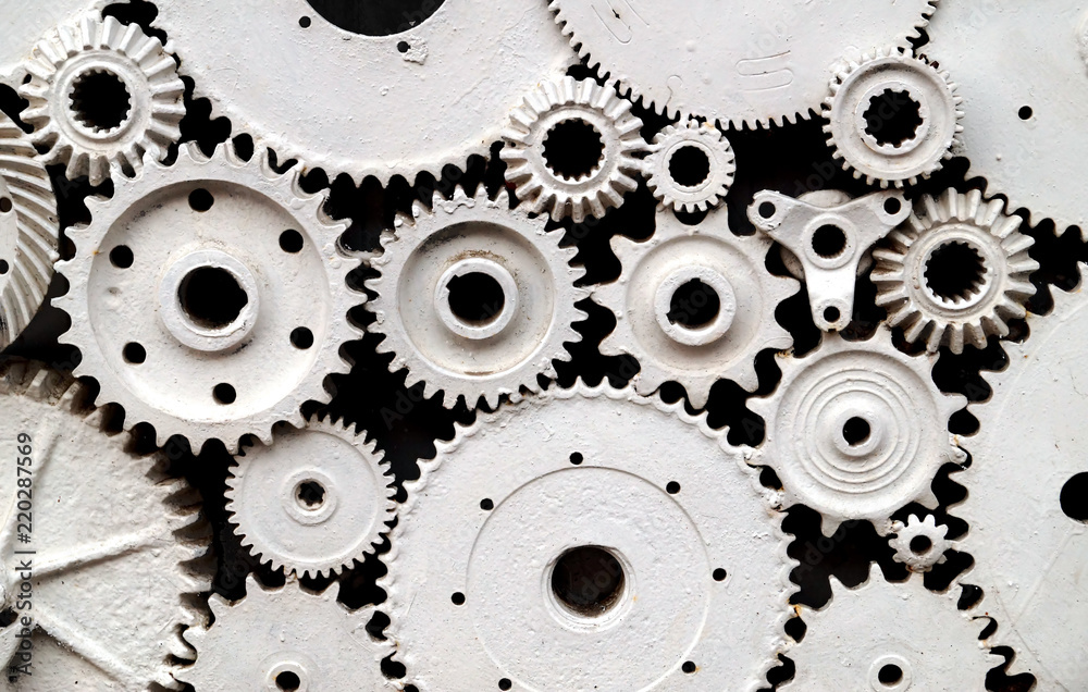 Cog wheels, old gears painted in white.