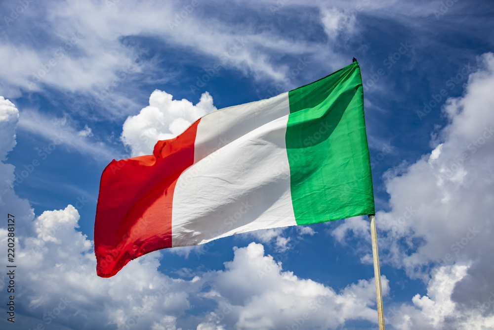 Italian flag waving in the blue sky Italian flag waving in the blue sky